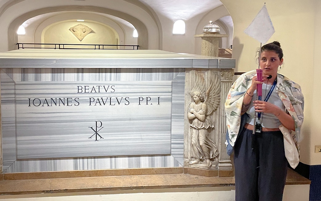 Tomb of Pope John Paul I in Vatican Grottoes, Vatican City, with a guide explaining.