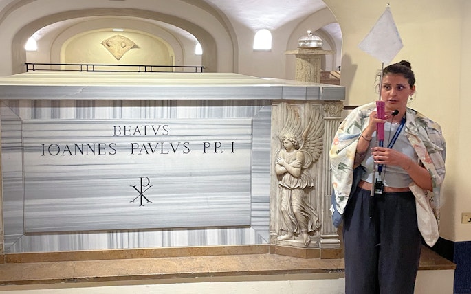 Tomb of Pope John Paul I in Vatican Grottoes, Vatican City, with a guide explaining.