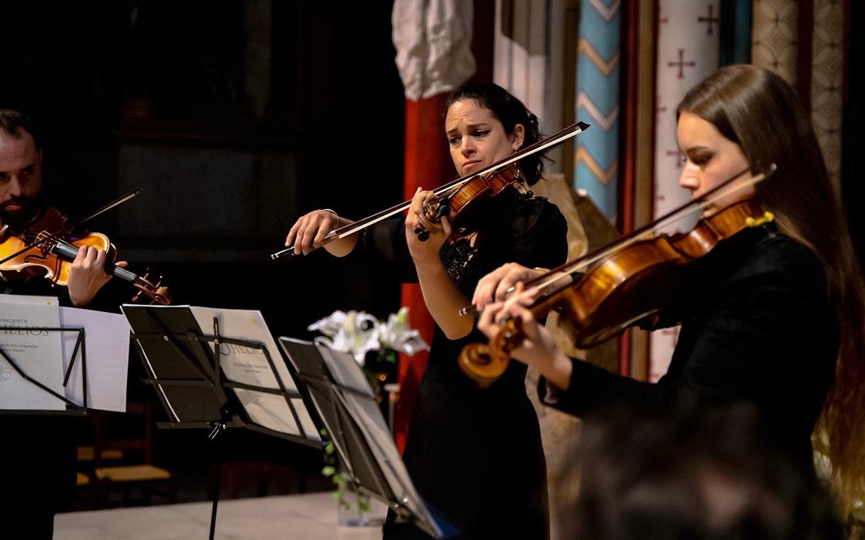 Musicians playing violins at St Germain des Prés Church, Paris, France.