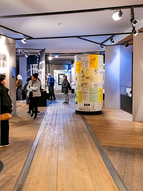 Guests exploring exhibits inside Terezin Concentration Camp museum.