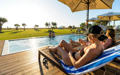 People relaxing by a pool at Top End Safari Camp, Finniss River, near Darwin.