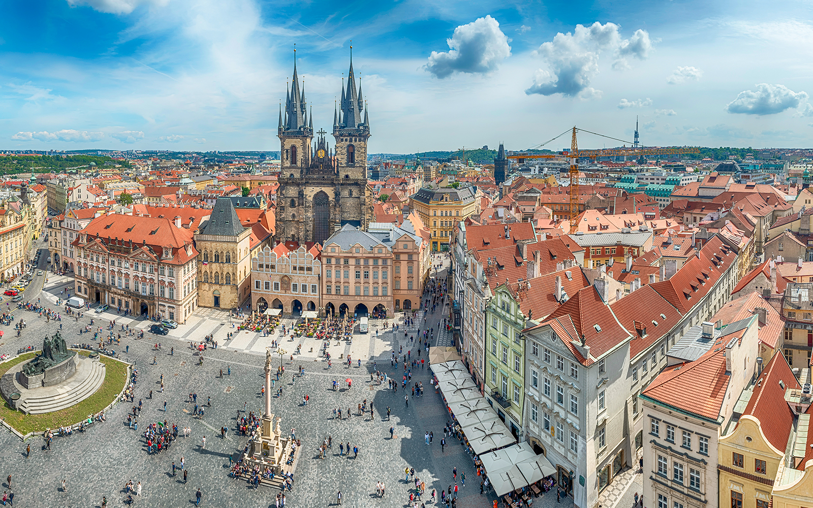 Aerial view of Tyn Church and Old Town Square crowded with people, Prague