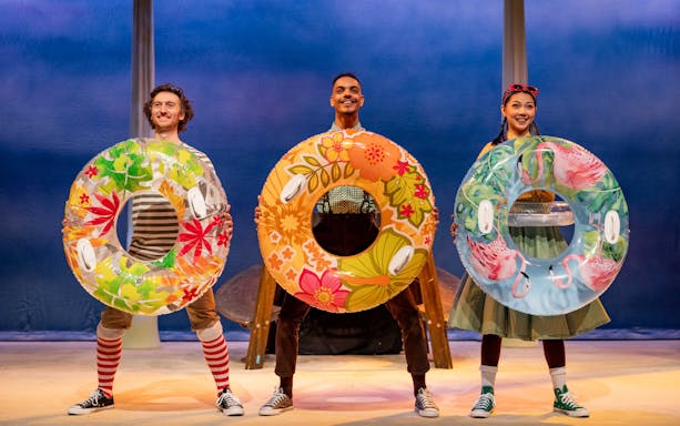 Performers with colorful float rings in Stick Man stage show, West End.