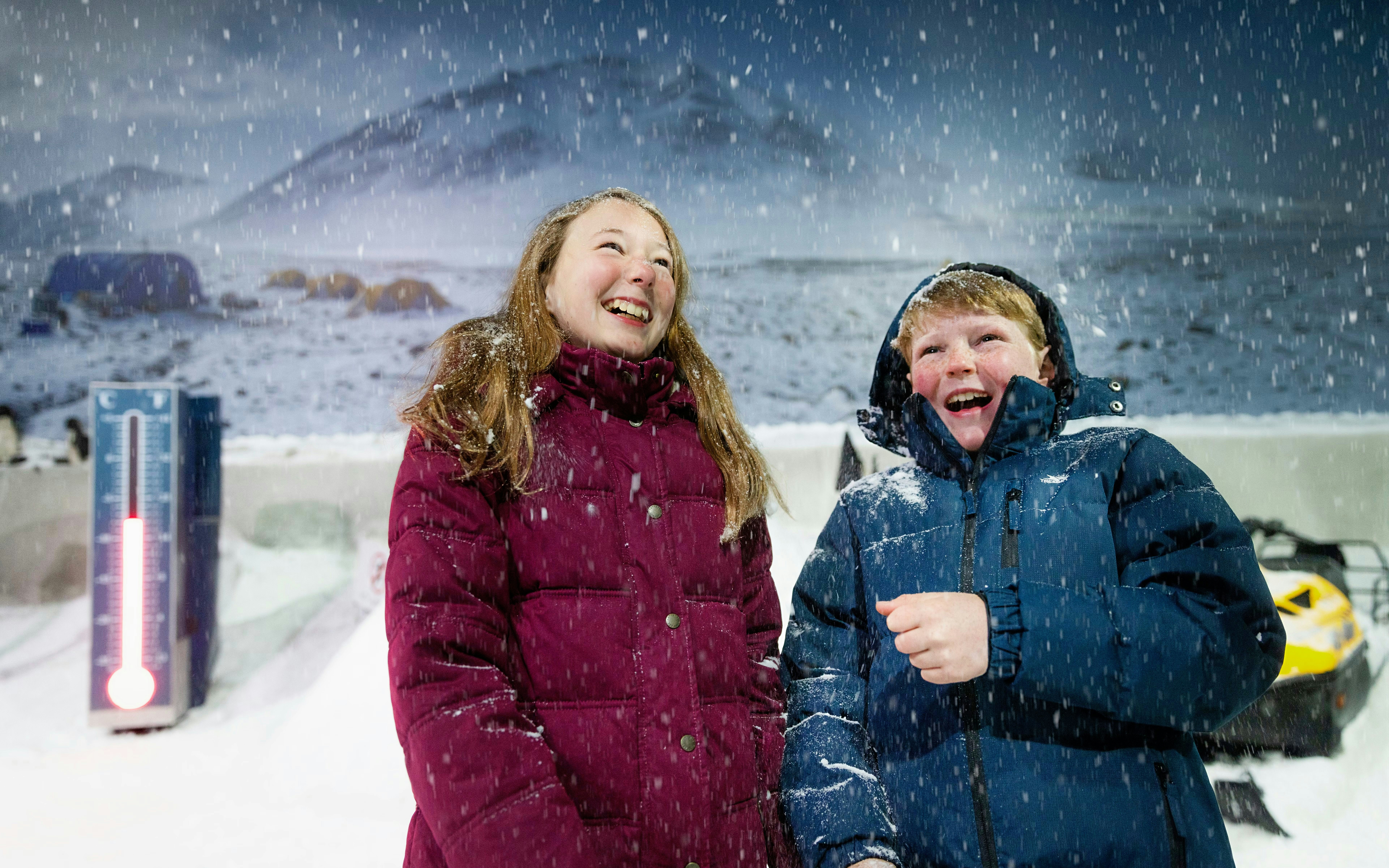 Visitors enjoying snow in the storm room at the International Antarctic Centre, Christchurch.