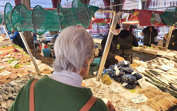 Venice market seafood stall with fresh fish and shellfish on display.