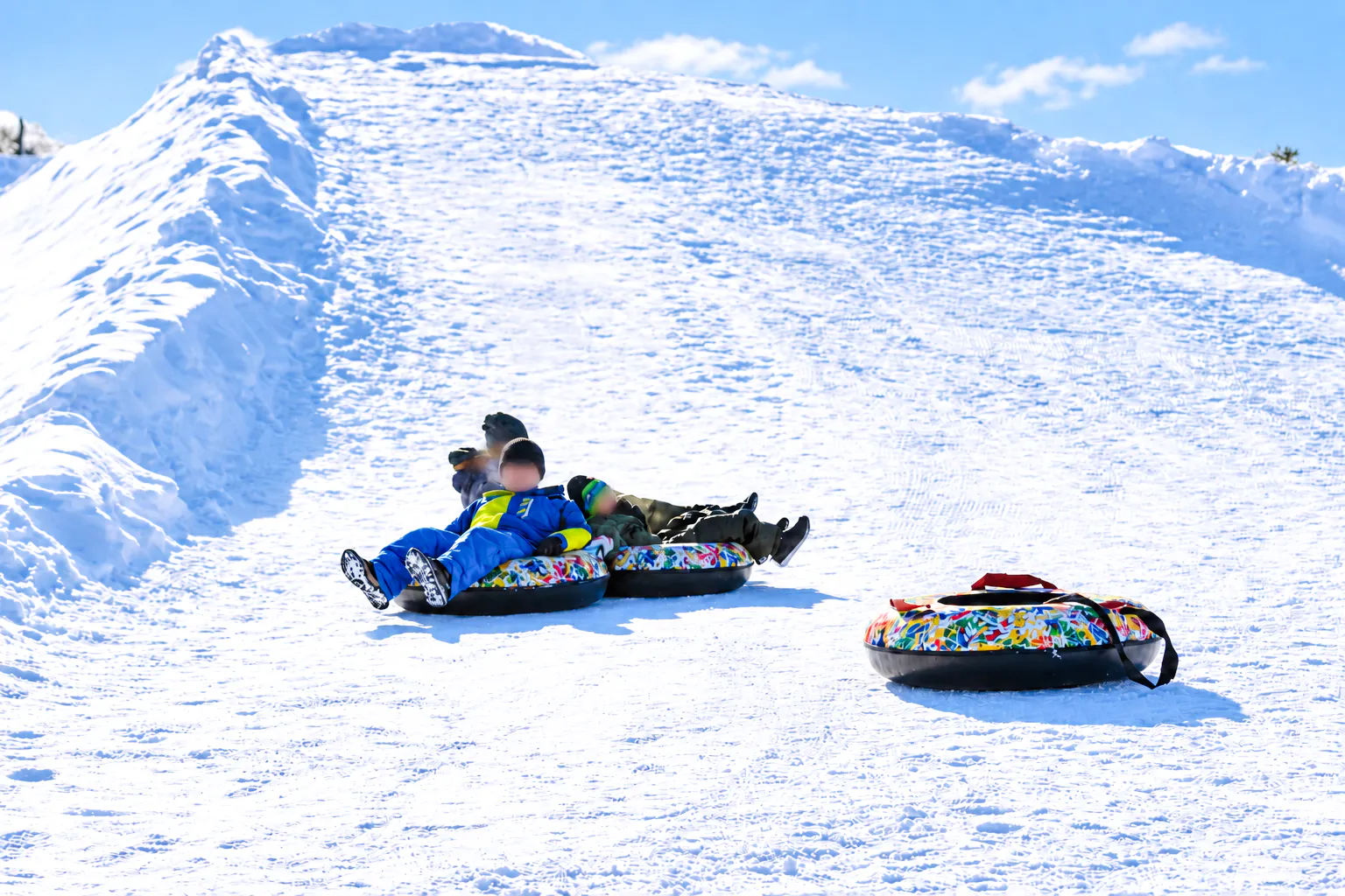 Snow tubing at a snowy hill in Sapporo's Otaru Snow Park, Hokkaido.