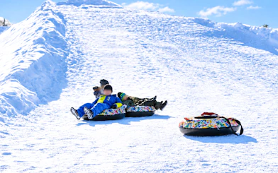 Snow tubing at a snowy hill in Sapporo's Otaru Snow Park, Hokkaido.