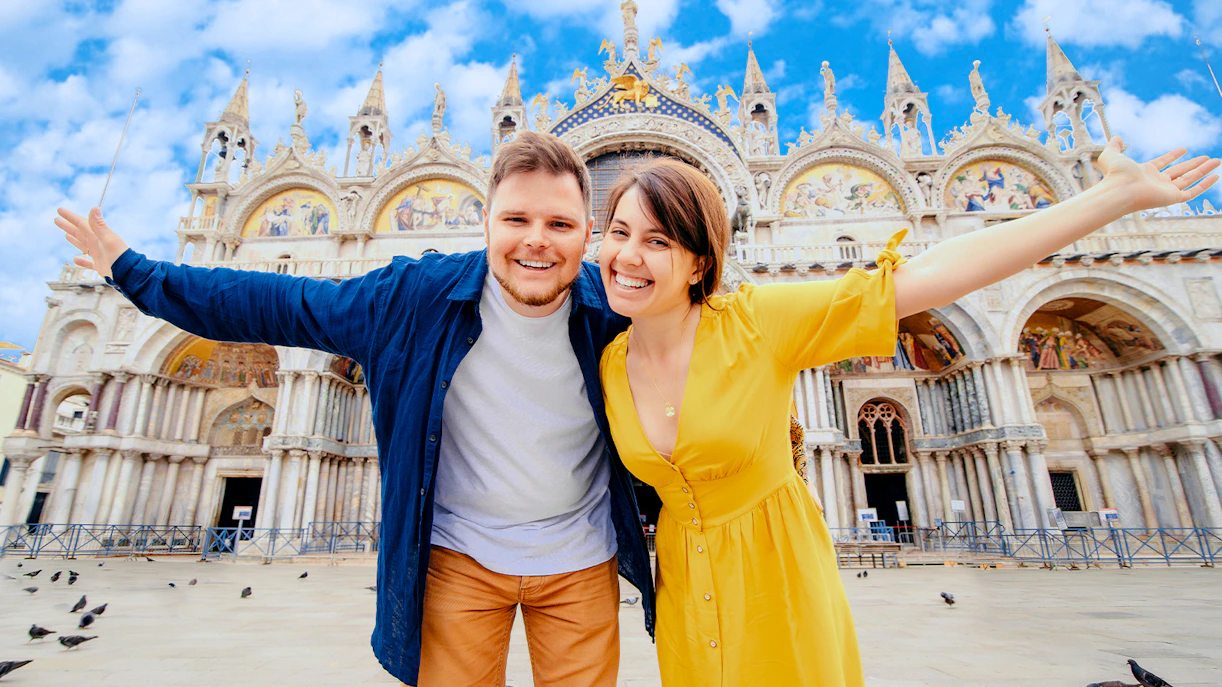 Visitors in front of St. Mark's Basilica, Venice, showcasing appropriate dress code.