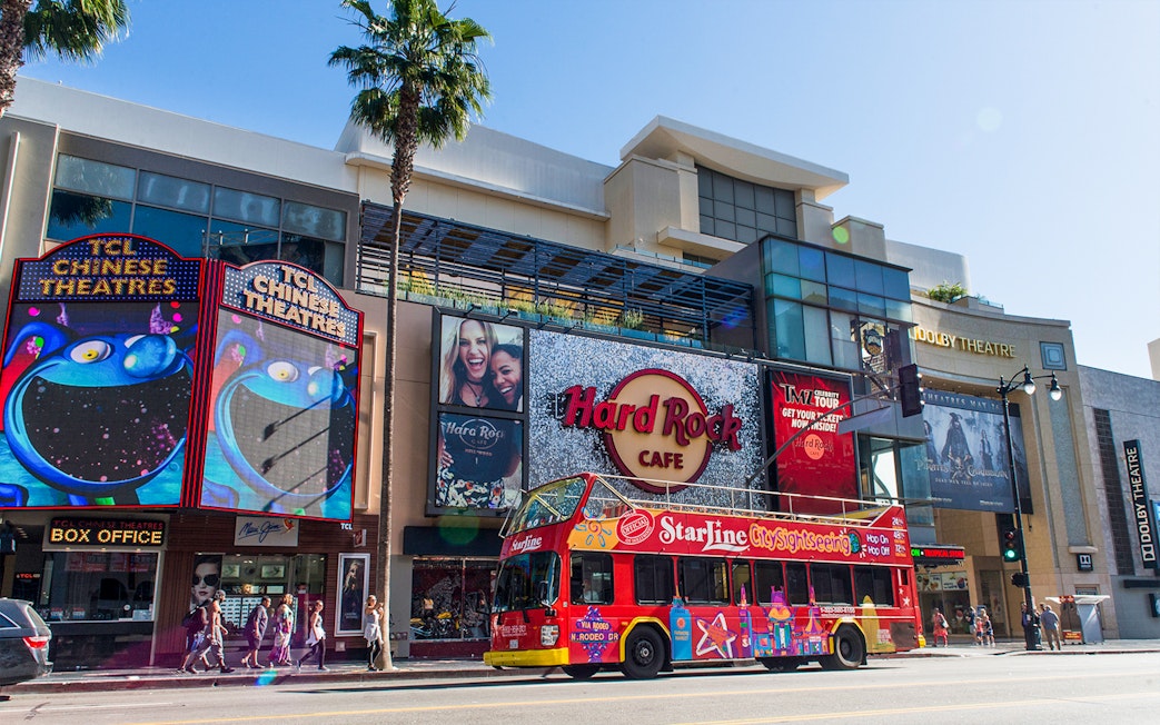 Hop-on hop-off tour bus in front of TCL Chinese Theatre and Hard Rock Cafe, Hollywood.