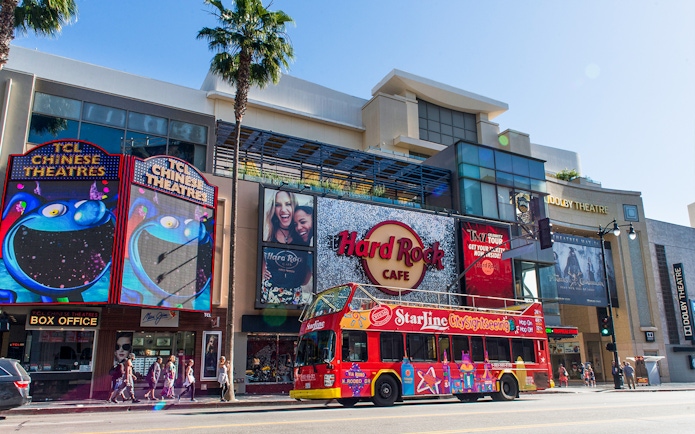 Hop-on hop-off tour bus in front of TCL Chinese Theatre and Hard Rock Cafe, Hollywood.
