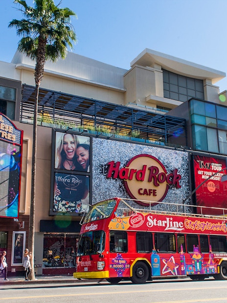 Hop-on hop-off tour bus in front of TCL Chinese Theatre and Hard Rock Cafe, Hollywood.