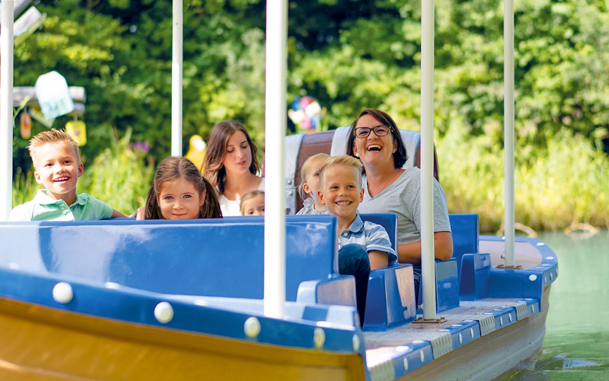 Families enjoying a boat ride at Ravensburger Spieleland.