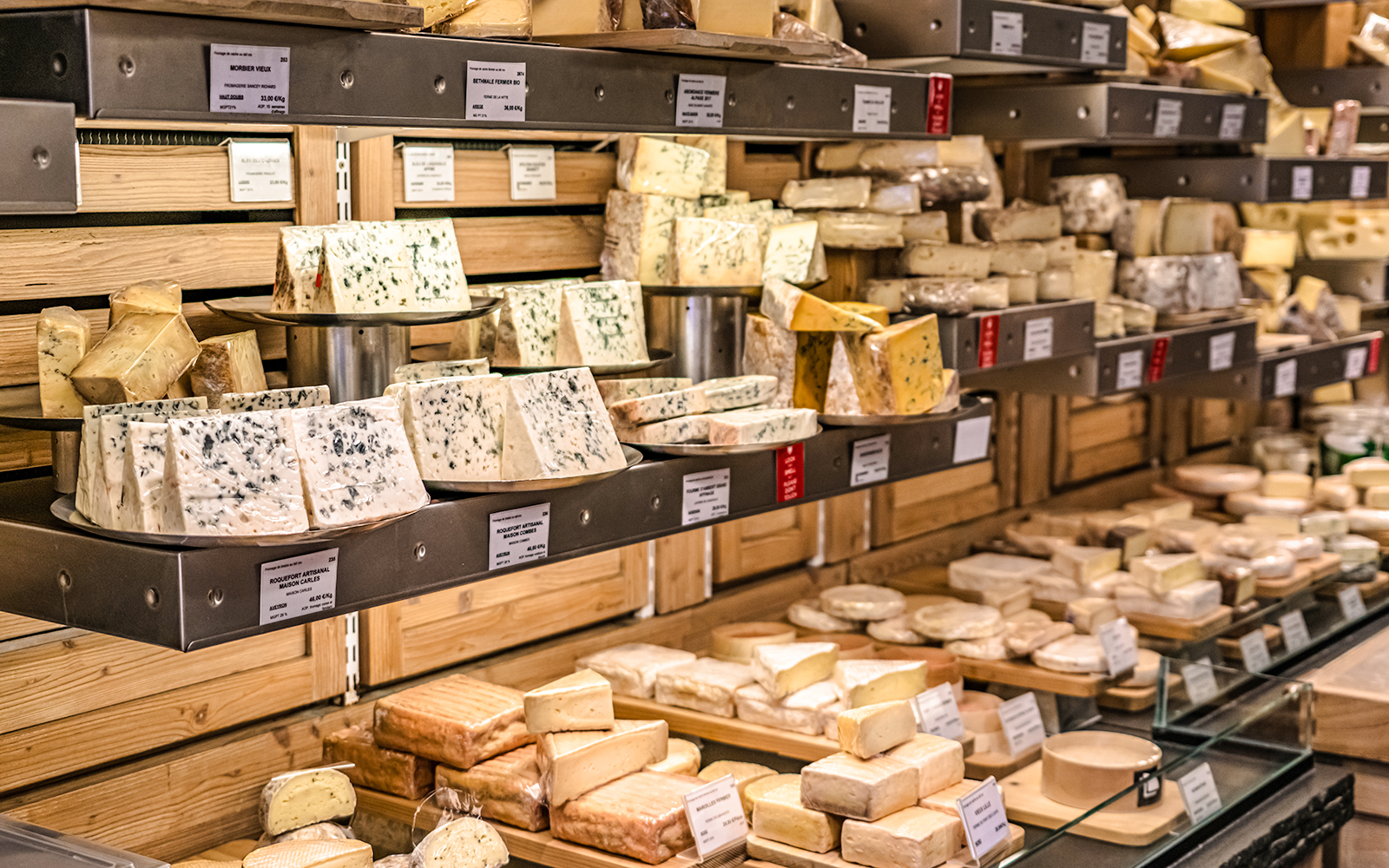 Assorted cheeses displayed on shelves at the Cheese Museum in Paris.
