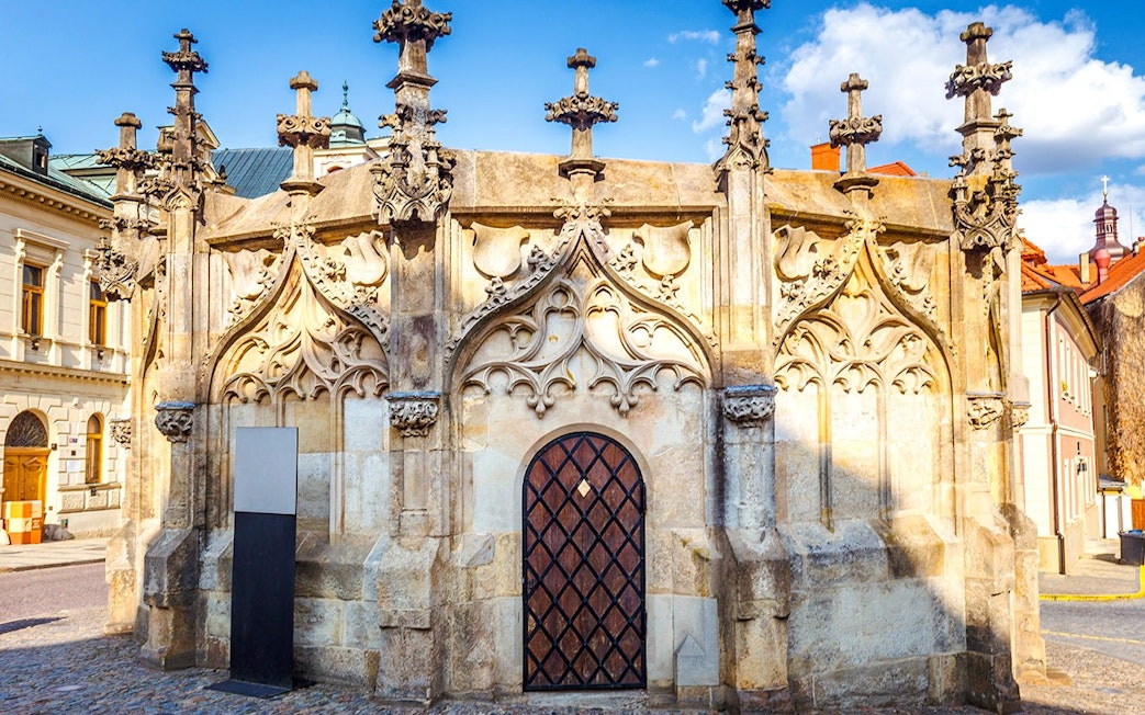 Gothic stone fountain in Kutna Hora with intricate carvings and spires.