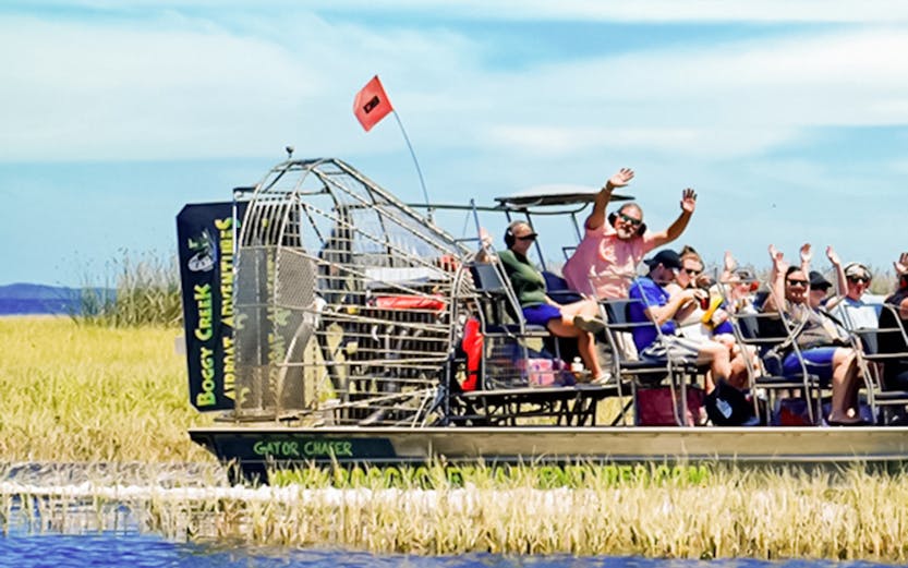 Airboat with tourists on Boggy Creek in Orlando.