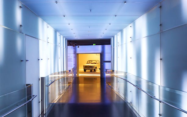 BMW Museum hallway leading to vintage car display, Munich.
