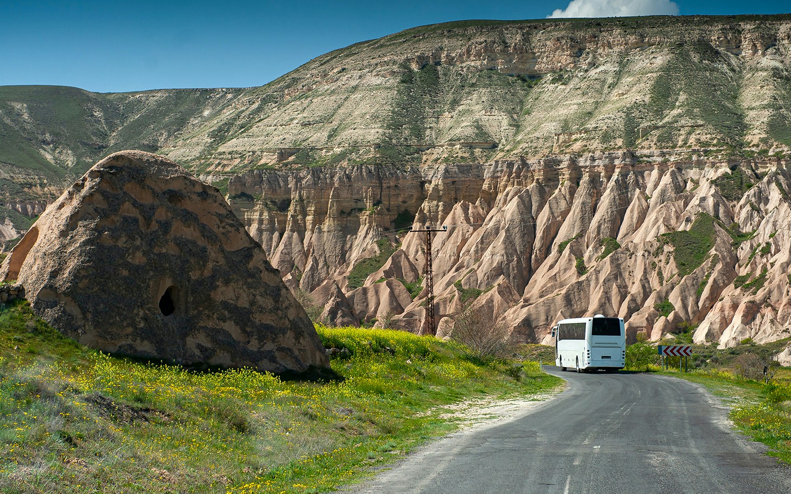 Bus traveling through Cappadocia's unique rock formations.