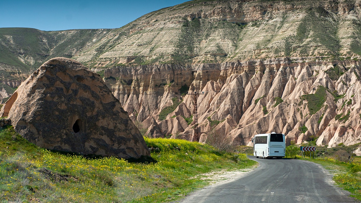 Bus traveling through Cappadocia's unique rock formations.