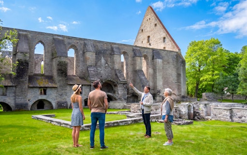Tour group exploring St. Bridget’s Convent ruins in Tallinn, Estonia.