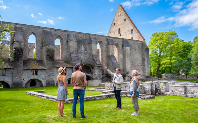 Tour group exploring St. Bridget’s Convent ruins in Tallinn, Estonia.