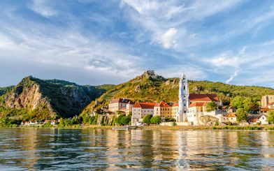 Dürnstein town with blue church tower and Danube River, Austria.