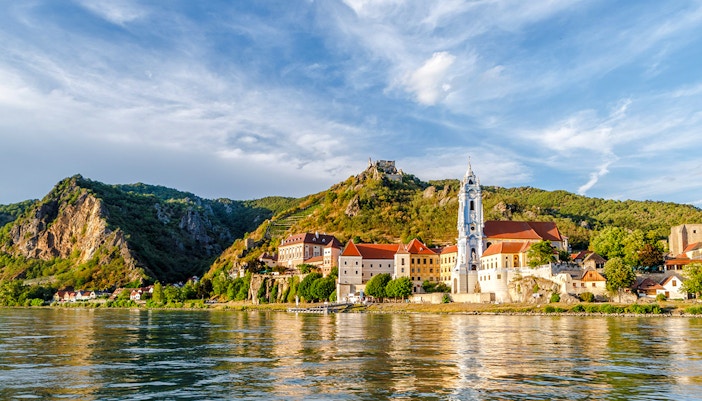 Dürnstein town with blue church tower and Danube River, Austria.