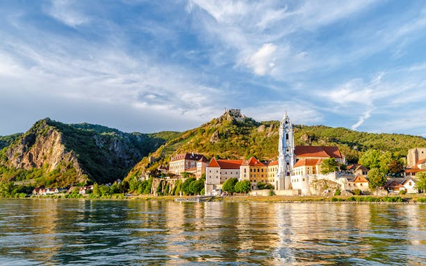 Dürnstein town with blue church tower and Danube River, Austria.