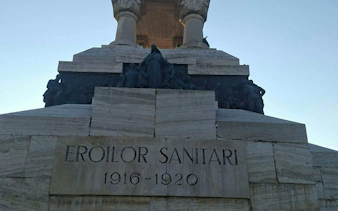 Eroilor Sanitari Monument inscription in Bucharest, part of self-guided city exploration game.