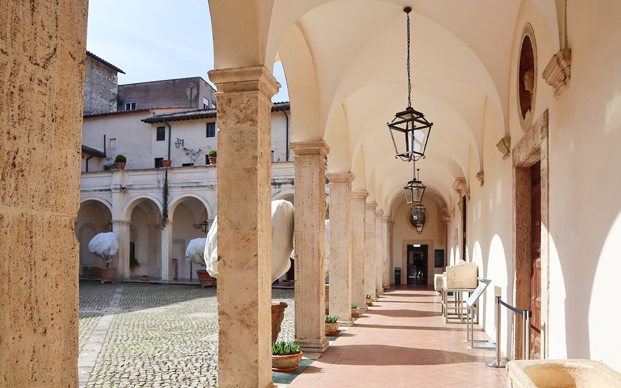Patio with arches and lanterns at Villa d'Este in Tivoli, Italy.