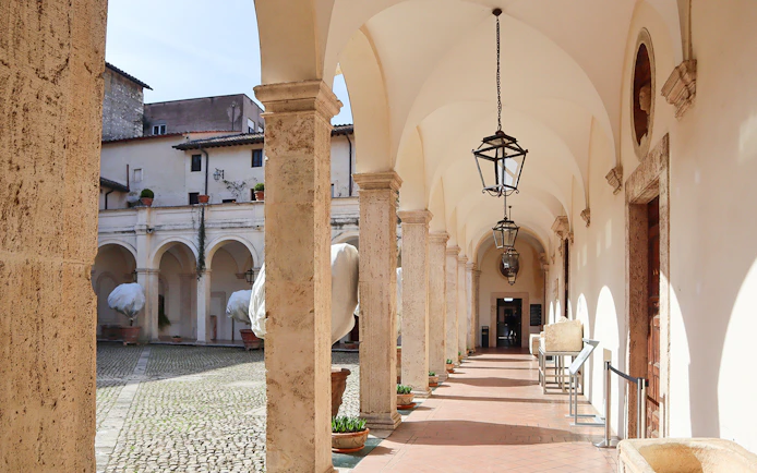 Patio with arches and lanterns at Villa d'Este in Tivoli, Italy.