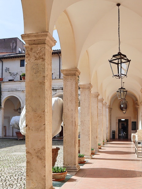 Patio with arches and lanterns at Villa d'Este in Tivoli, Italy.