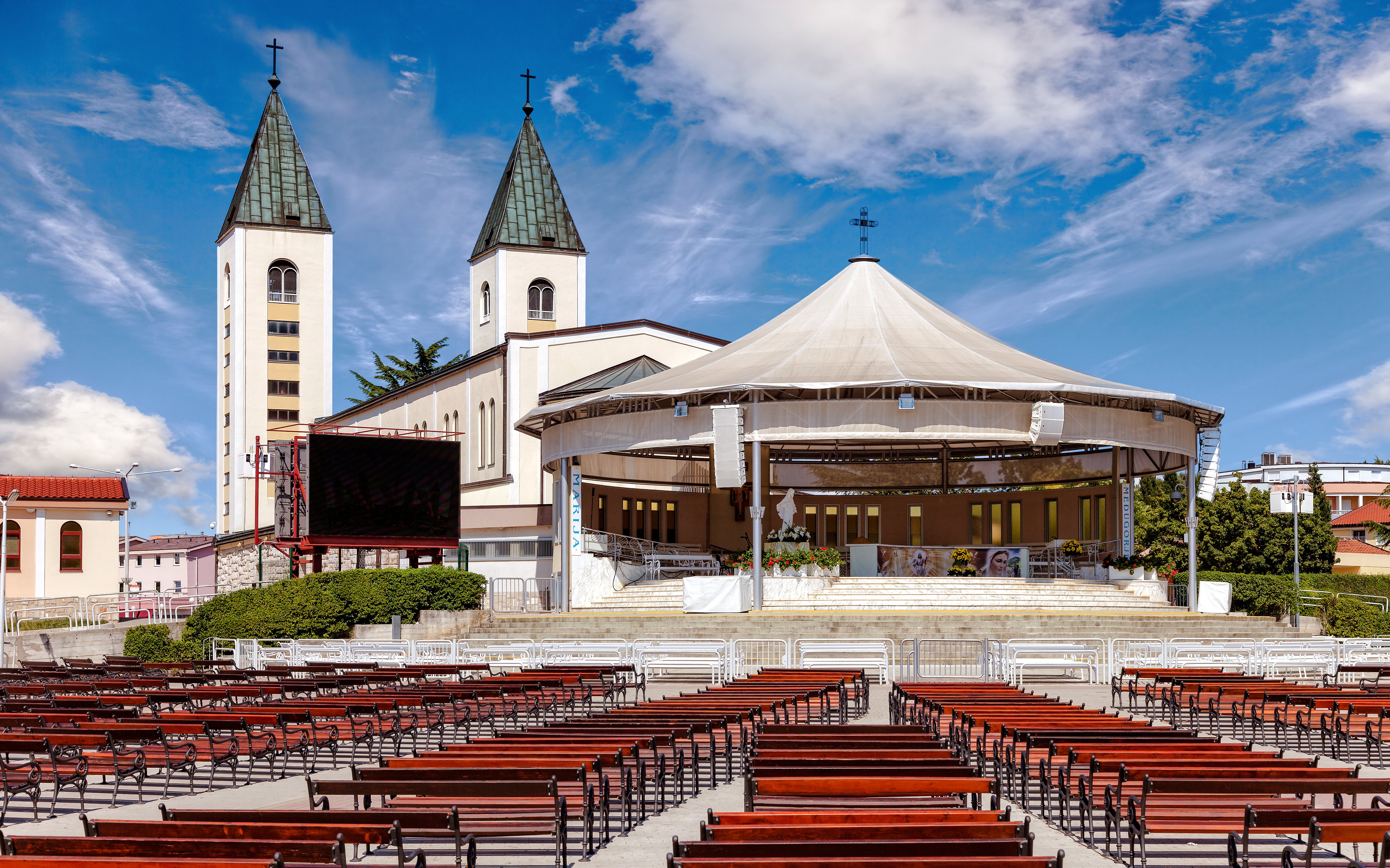Saint James Church in Medjugorje with outdoor seating, Bosnia and Herzegovina.
