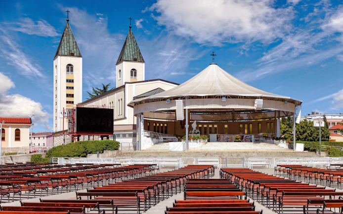 Saint James Church in Medjugorje with outdoor seating, Bosnia and Herzegovina.