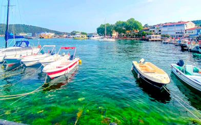 Boats docked at the harbour in Princes Islands, Istanbul, with waterfront buildings in the background.