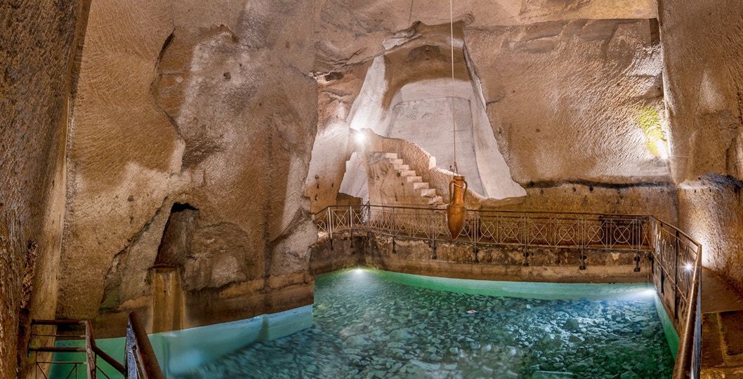 Bourbon Gallery in Naples underground ruins, featuring ancient Napoli sotterranea architecture.
