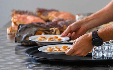 Plates of local Arctic cuisine being served on the Tromso Fjord Cruise.