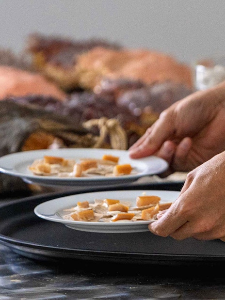 Plates of local Arctic cuisine being served on the Tromso Fjord Cruise.