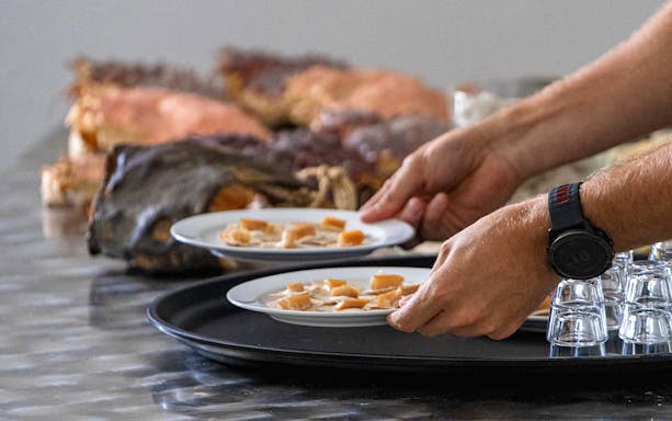 Plates of local Arctic cuisine being served on the Tromso Fjord Cruise.