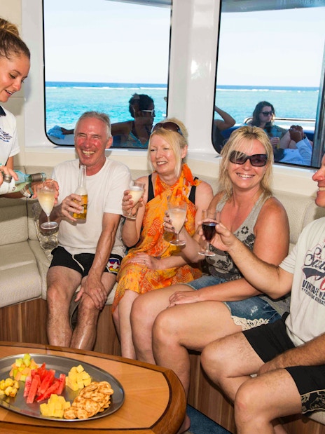 Cruise passengers enjoying drinks and snacks on Great Barrier Reef tour.