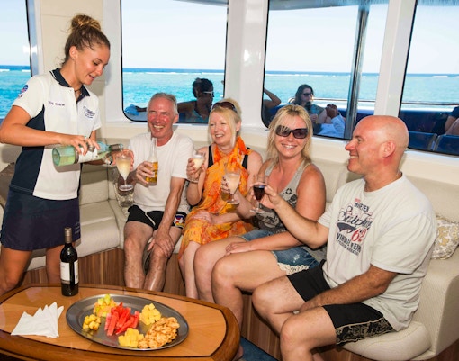 Cruise passengers enjoying drinks and snacks on Great Barrier Reef tour.