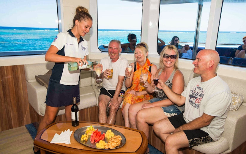 Cruise passengers enjoying drinks and snacks on Great Barrier Reef tour.