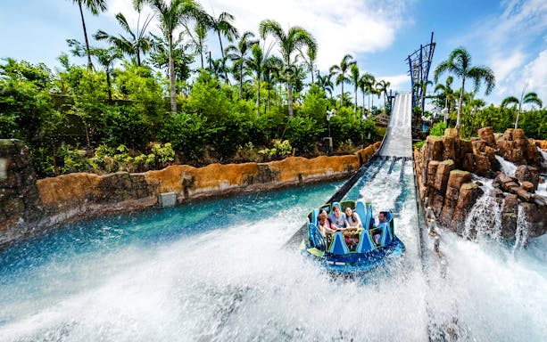 Raft descending the Infinity Falls river rapids ride at SeaWorld Orlando.
