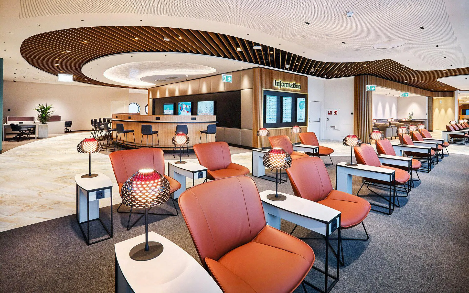Vienna Airport Terminal 1 lounge seating area with information desk.