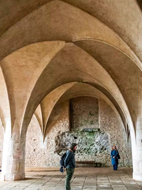 Visitors inside the Bone Church in Kutna Hora, admiring vaulted ceilings and stone walls.