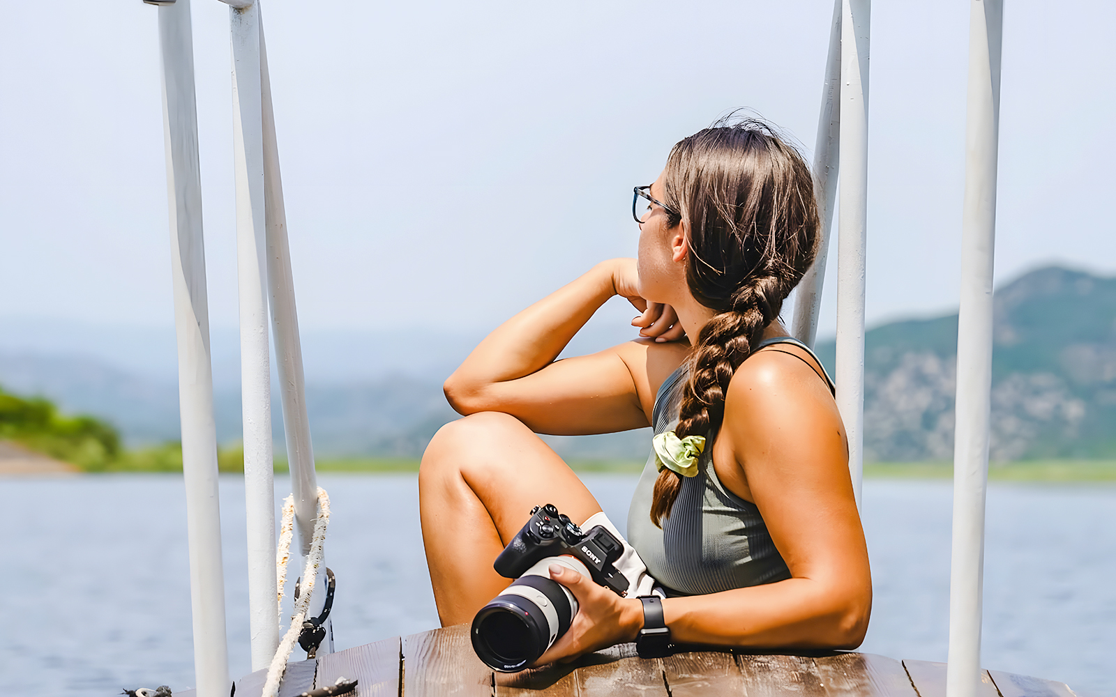 Tourist with camera on a boat at Lake Skadar, Montenegro.