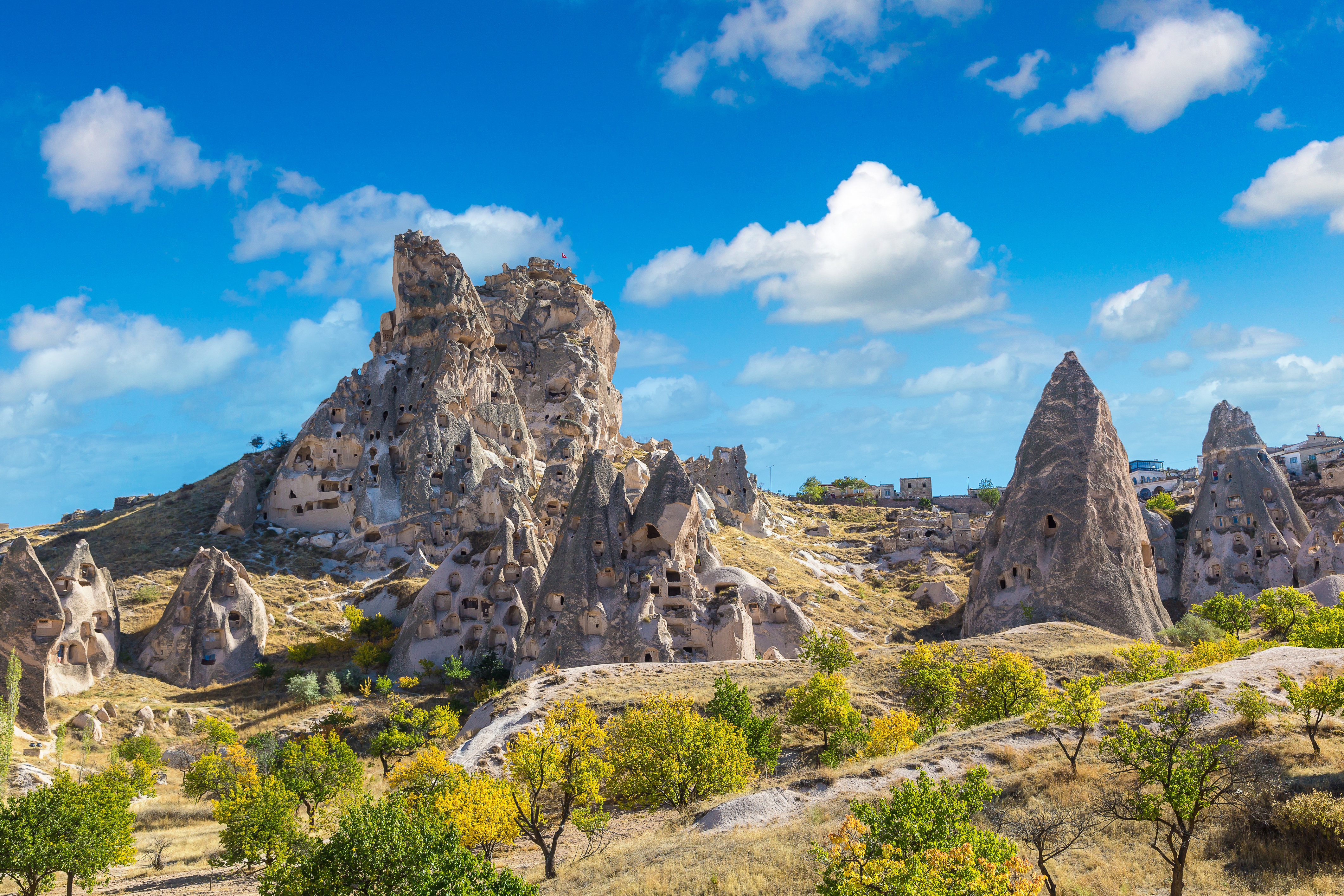 Goreme Open Air Museum rock formations under a blue sky in Cappadocia, Turkey.