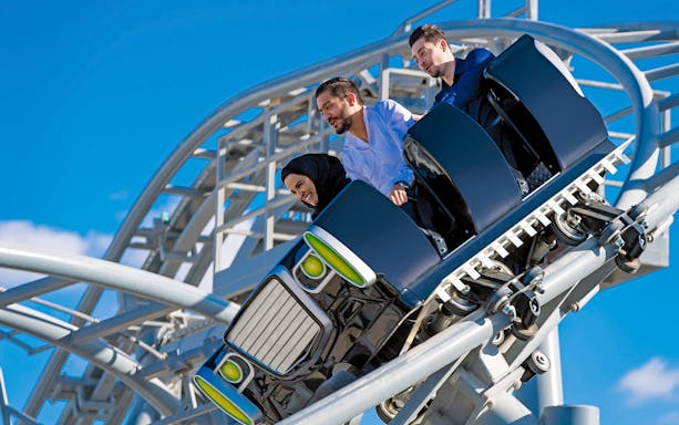 Riders on The Green Hornet High Speed Chase roller coaster at Motiongate Dubai.