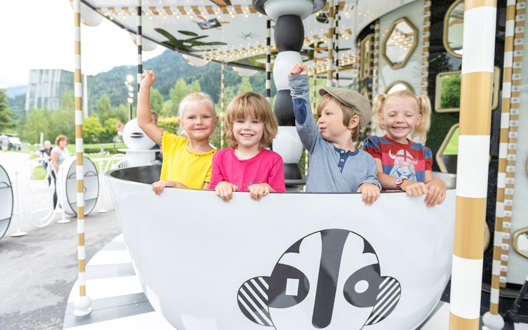 Children enjoying a ride at Swarovski Crystal Worlds, Austria.