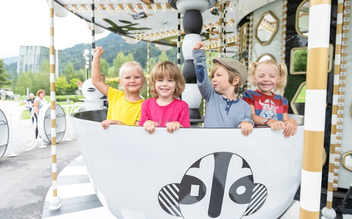 Children enjoying a ride at Swarovski Crystal Worlds, Austria.