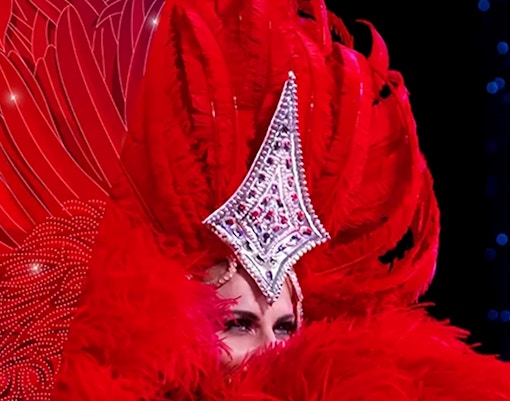 Performer in red feathered costume at Moulin Rouge Valentine's Day event.